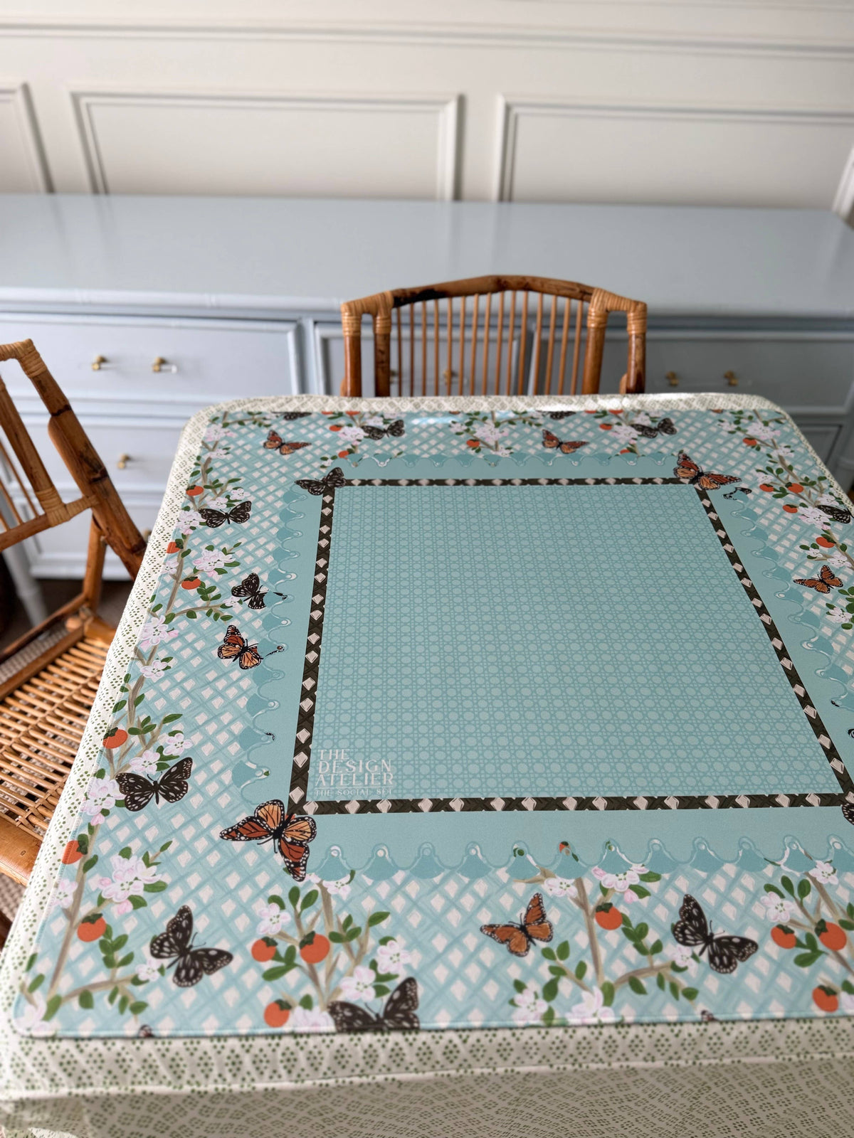 The Linden House Mahjong Mat by The Design Atelier styled on a game table with blue floral and butterfly design